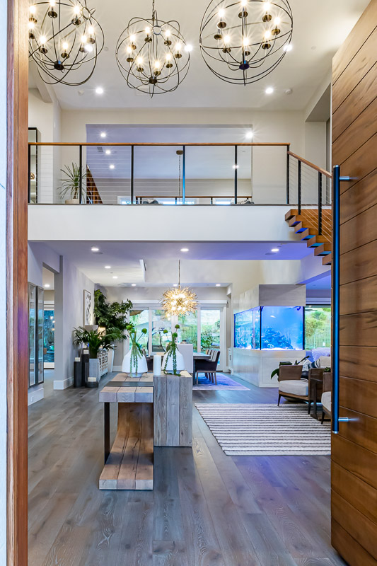 walking through the custom mahogany front door visitors a greeted with a grand foyer leading to a dining room and massive salt water fish tank